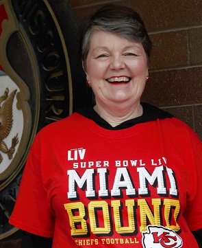 Barbara Glesner Fines smiles while wearing Chiefs Superbowl t-shirt